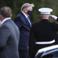 U.S. President Donald Trump exits Marine One while arriving to Walter Reed National Military Medical Center in Bethesda, Maryland, on Friday. Trump was being treated for COVID-19, which he announced after one of his closest aides had tested positive for the virus. | BLOOMBERG