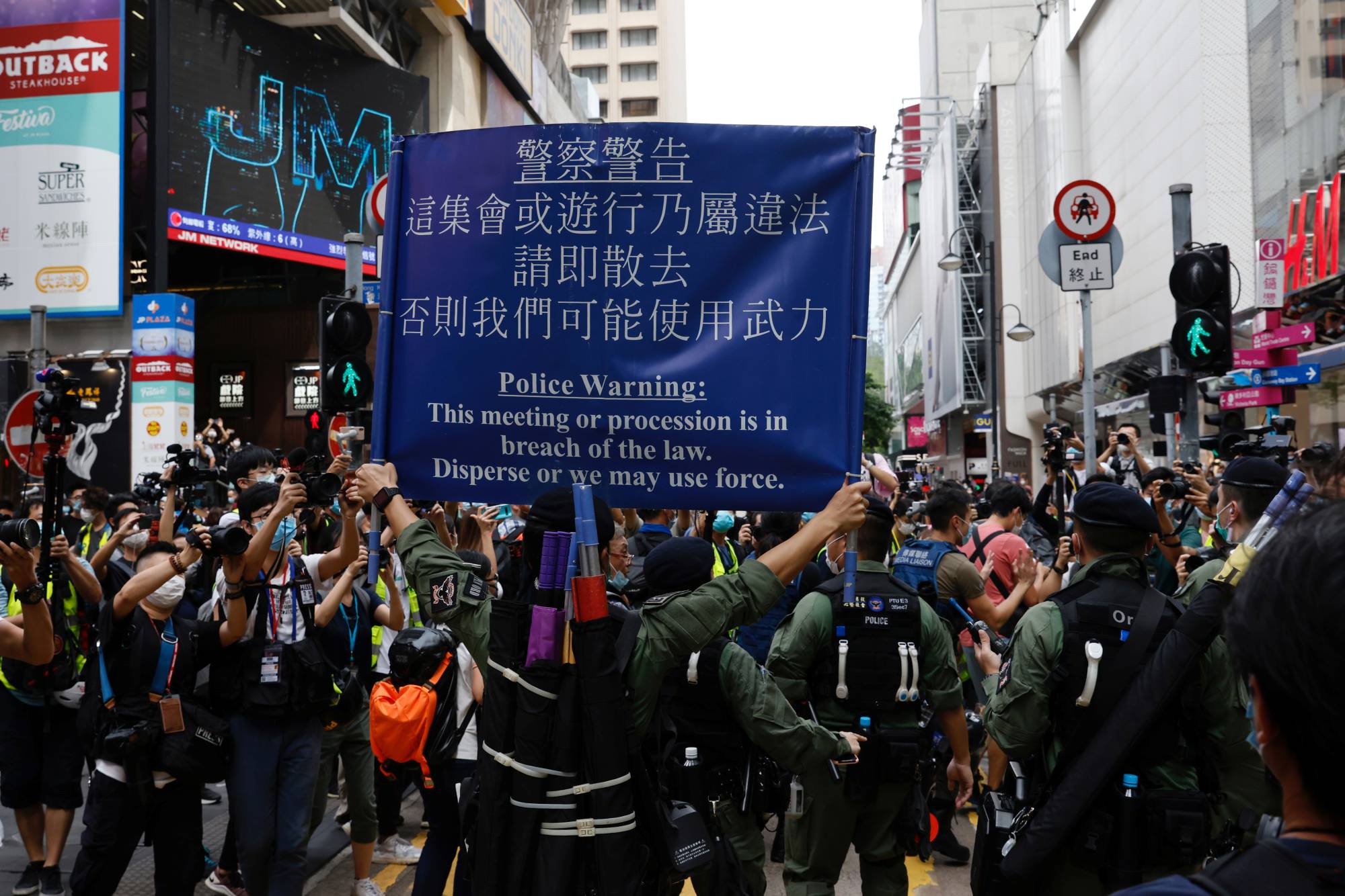 Police ask people to leave during a protest urging the release of 12 Hong Kong activists, detained on the Chinese mainland, who were arrested at sea after attempting to flee to Taiwan, on Chinese National Day in Hong Kong on Thursday.  | REUTERS 