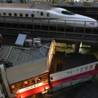 A Shinkansen bullet train travels along an elevated railway track near Yurakucho station in Tokyo. | BLOOMBERG
