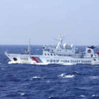A Chinese government vessel approach the contiguous waters surrounding the Japanese-controlled Senkaku Islands. | JAPAN COAST GUARD / VIA KYODO
