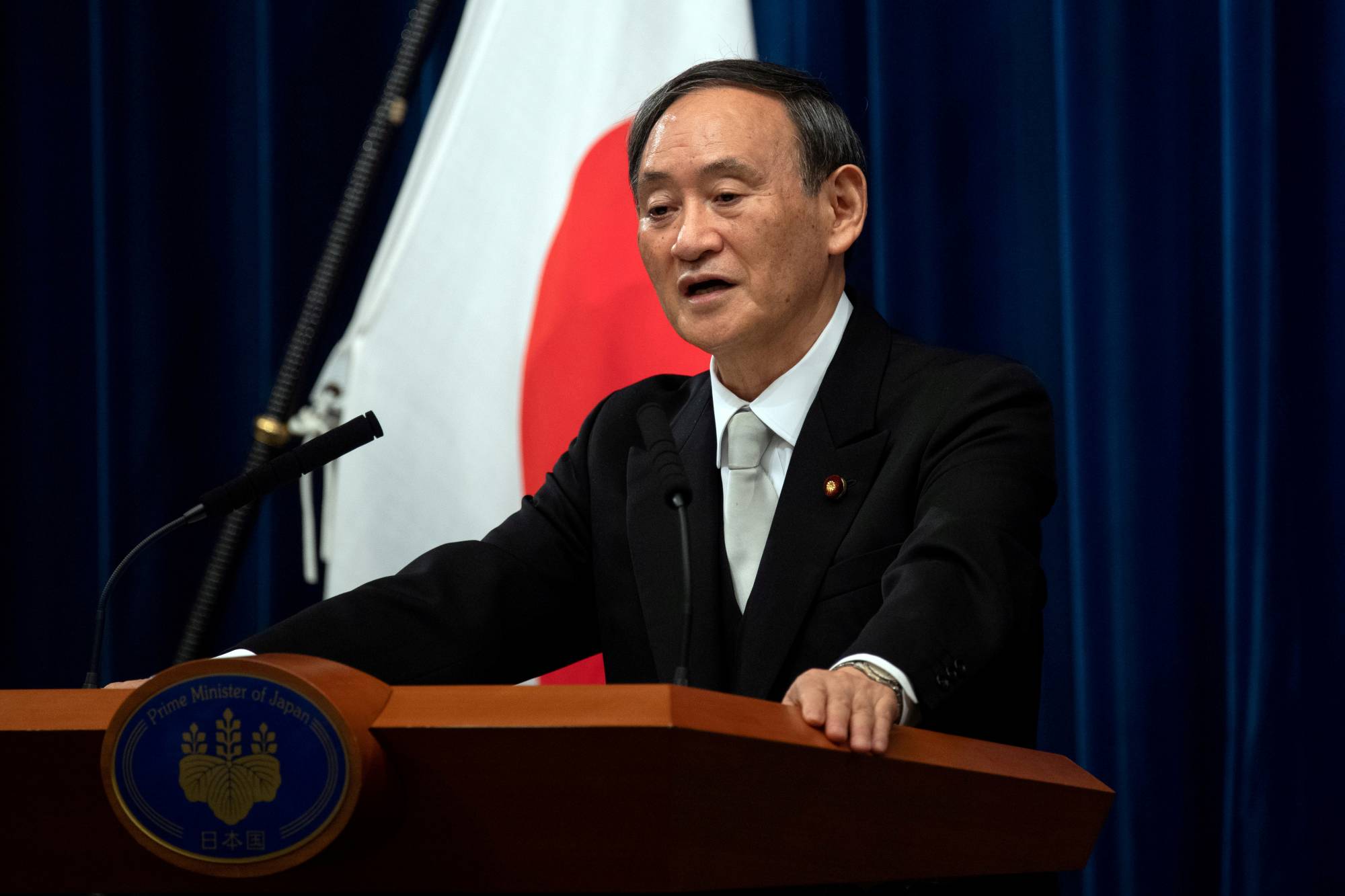 Yoshihide Suga speaks during a news conference in Tokyo on Sept. 16. following his confirmation as Prime Minister in Tokyo. Suga has denied that the rejection of six scholars to the Science Council of Japan is attributed to their criticism of national security legislation approved under then-Prime Minister Shinzo Abe. | POOL / VIA REUTERS
