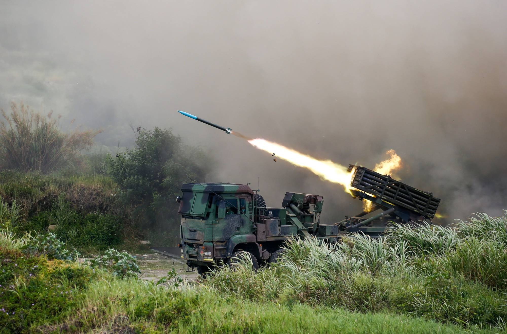 A Thunderbolt 2000 multiple rocket launcher fires munitions during a military exercise in Taichung, Taiwan, in July. | BLOOMBERG 