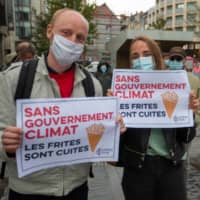 People take part in a demonstration calling for action on climate change in Brussels on Sept. 25.  | AFP-JIJI