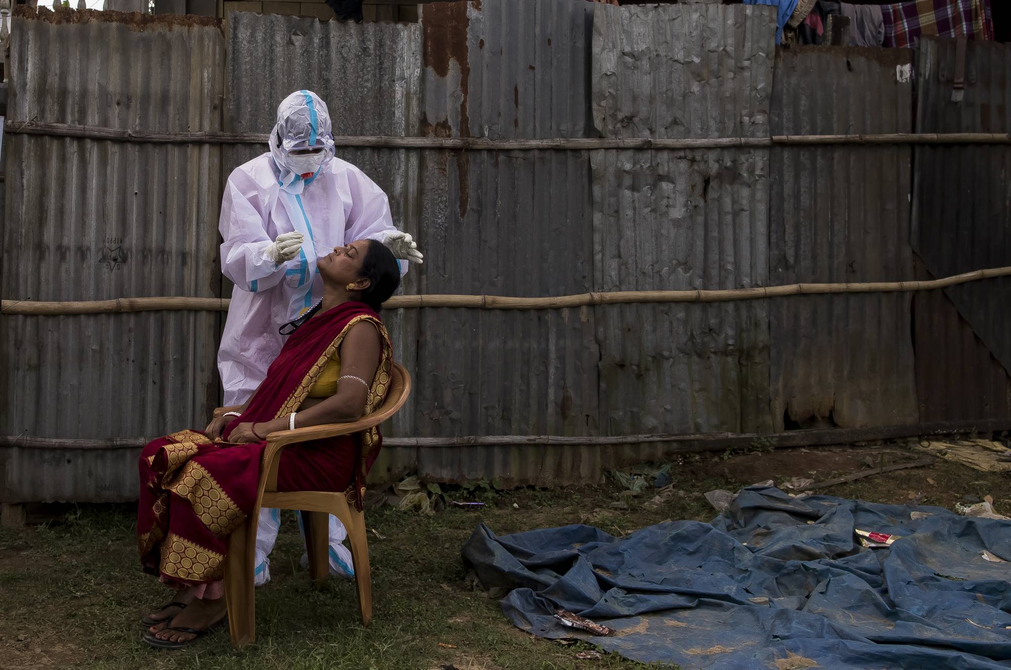 A health worker performs a coronavirus test in Masli, in the state of Tripura, India.  | ANINDITO MUKHERJEE / THE NEW YORK TIMES