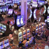 The central government is set to postpone the procedure to accept bids from municipalities to host casino resorts, which was originally scheduled to start in January. | KYODO
