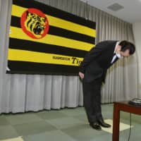 Tigers president Kenji Ageshio bows during a news conference in Nishinomiya, Hyogo Prefecture, on Friday. | POOL / VIA KYODO