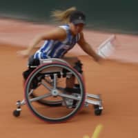 Yui Kamiji plays a shot during her win in the French Open women\'s wheelchair final on Friday in Paris. Kamiji failed to clinch the women\'s doubles title on Saturday with her partner Jordanne Whiley. | AP