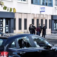 This photo shows the broken windows of a car outside the police station of Champigny-sur-Marne, near Paris, on Sunday, the morning after the station was attacked by around 40 people launching fireworks.  | AFP-JIJI