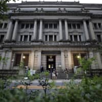The Bank of Japan’s growing pile of assets is complicating its strategy to exit stimulus, economists say. | BLOOMBERG