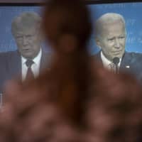 Viewers look on at the first presidential debate between President Donald Trump and Joe Biden, during a watch party in Lititz, Pennsylvania, on Sept. 29. | MARK MAKELA / THE NEW YORK TIMES