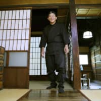 Mitsumaro Sato, who has bought a historic \"ninja house,\" poses at the property in Hirosaki, Aomori Prefecture, on Tuesday.  | KYODO
