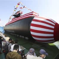 Japan\'s newest submarine, the Taigei, is unveiled Wednesday at a Mitsubishi Heavy Industries Ltd. shipyard in Kobe. | KYODO