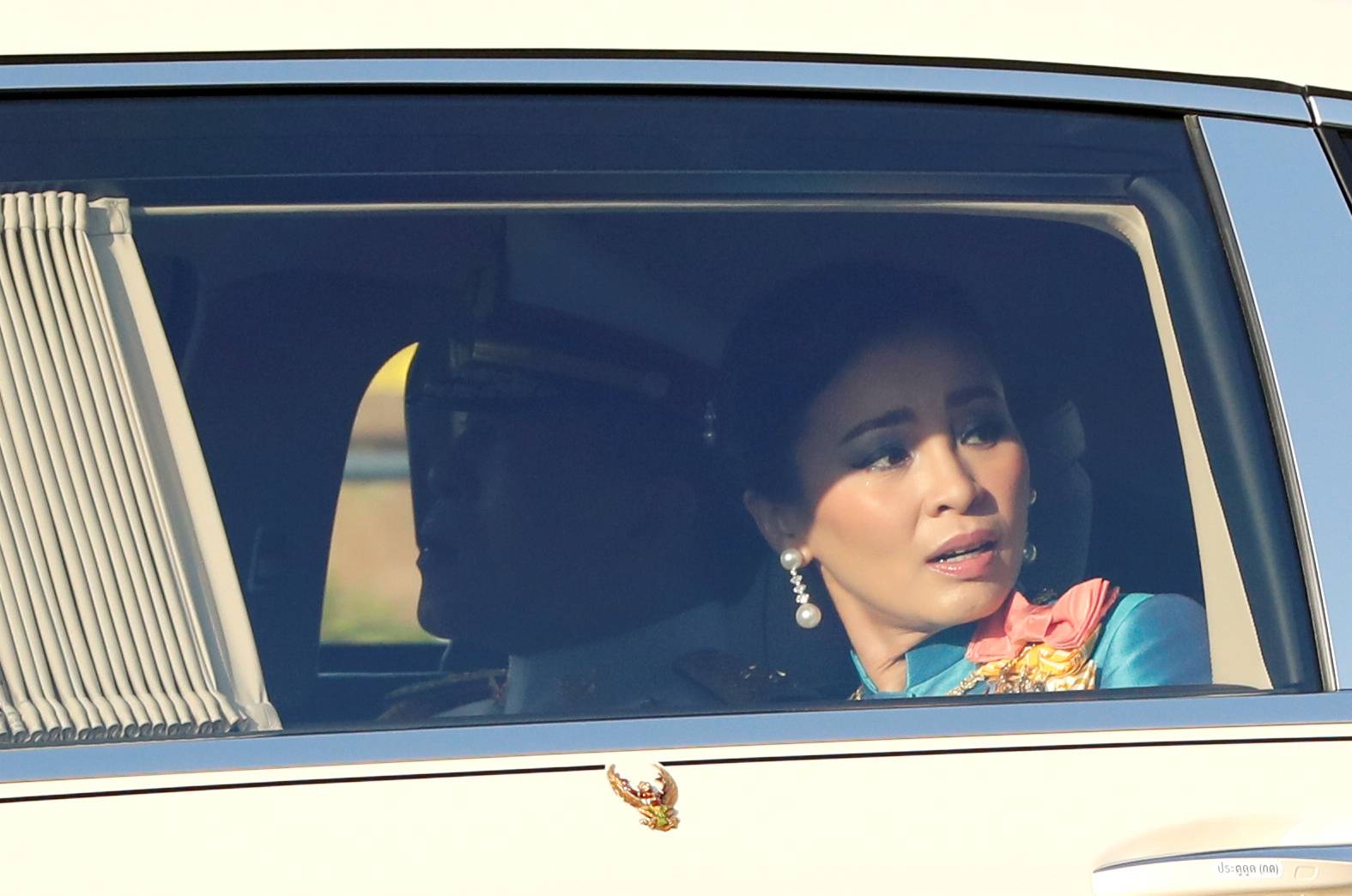 A car carrying Thailand's King Maha Vajiralongkorn and Queen Suthida drives toward the Grand Palace in Bangkok on Wednesday.  | REUTERS 