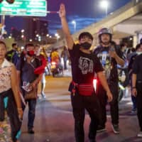 A small group of pro-democracy protesters near the Government House in Bangkok on Thursday. | AP