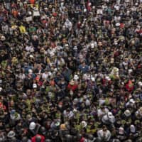 Pro-democracy protesters gathered by the thousands in Bangkok on Wednesday.  | ADAM DEAN / THE NEW YORK TIMES
