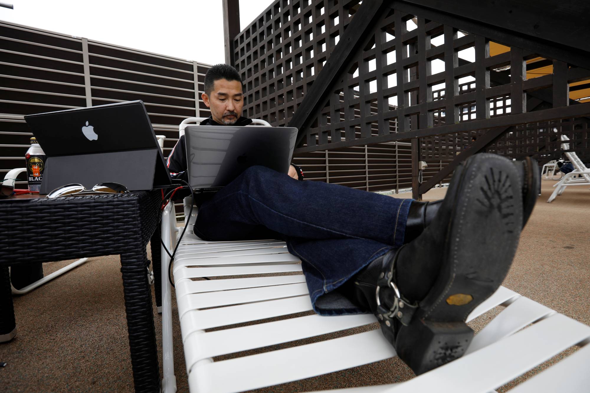 Fleq President Tatsuki Yamamoto works on a pool deck chair at Yomiuriland in Tokyo on Thursday. | REUTERS
