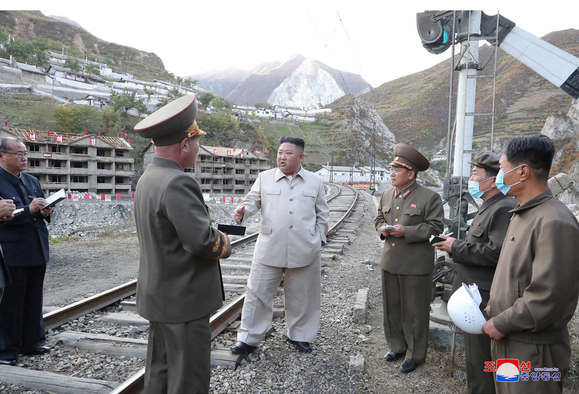 North Korean leader Kim Jong Un inspects a damage recovery site affected by heavy rains and winds caused by recent typhoons in South Hamgyong province in a photo released Tuesday.  | KCNA / VIA REUTERS