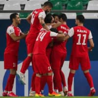 Persepolis players celebrate a goal during an Asian Champions League group stage match against Saudi Arabia\'s Al-Taawoun on Sept. 18 in Doha. | AFP-JIJI