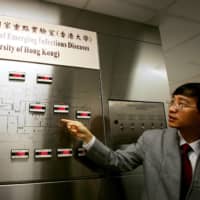 Yuen Kwok-Yung of the University of Hong Kong introduces a newly set up state laboratory for the study of emerging infectious diseases in Hong Kong in 2004.  | REUTERS
