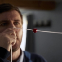 Mark Lenzi uses a Brock string for vision therapy at his home in Durham, New Hampshire. Lenzi, who worked for the State Department in Guangzhou, China, experiences the same mysterious affliction as dozens of staff members at the American Embassy in Havana. | CODY O\'LOUGHLIN / THE NEW YORK TIMES