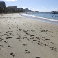 A near-empty Waikiki Beach is viewed on Thursday in Honolulu. A new travel testing program allows visitors from Japan who test negative for COVID-19 to come to Hawaii and avoid two weeks of mandatory quarantine. | AP
