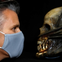 Stephen Lane with a special effects mechanical head from the film \"Alien\"  | REUTERS