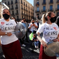 Members of the hospitality sector in Barcelona, Spain, protest an order to close bars and restaurants, on Oct. 16.  Among the nations with the highest death rates per million people, 6 out of the top 10 are Spanish-speaking.
 | REUTERS