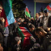 Mourners attend the funeral of Eldar Aliyev, a 26-year-old who died fighting in the war against Armenia, in Baku on Oct. 18. | IVOR PRICKETT / THE NEW YORK TIMES