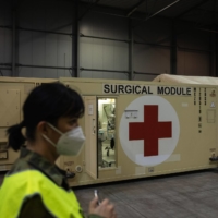 Newly installed shipping containers converted to \"surgical modules\" for COVID-19 patients are installed in the Letnany exhibition hall in Prague on Thursday. | BLOOMBERG