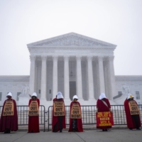 Demonstrators protest against the nomination of Judge Amy Coney Barrett outside the Supreme Court in Washington on Thursday. | PETE MAROVICH / THE NEW YORK TIMES