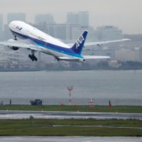 An ANA aircraft takes off from Haneda Airport in Tokyo on Friday. Most of ANA\'s international routes are suspended, and a resurgence of infections in Western countries means a revival of inbound tourism may be some time off. | REUTERS