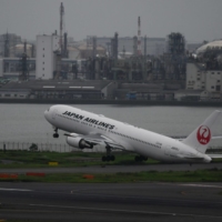 A Japan Airlines aircraft takes off at Haneda Airport in Tokyo on July 28. | BLOOMBERG