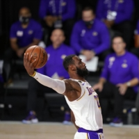 The Lakers\' LeBron James dunks during the first half in Game 6 of the NBA Finals in Lake Buena Vista, Florida, on Oct. 11. | AP