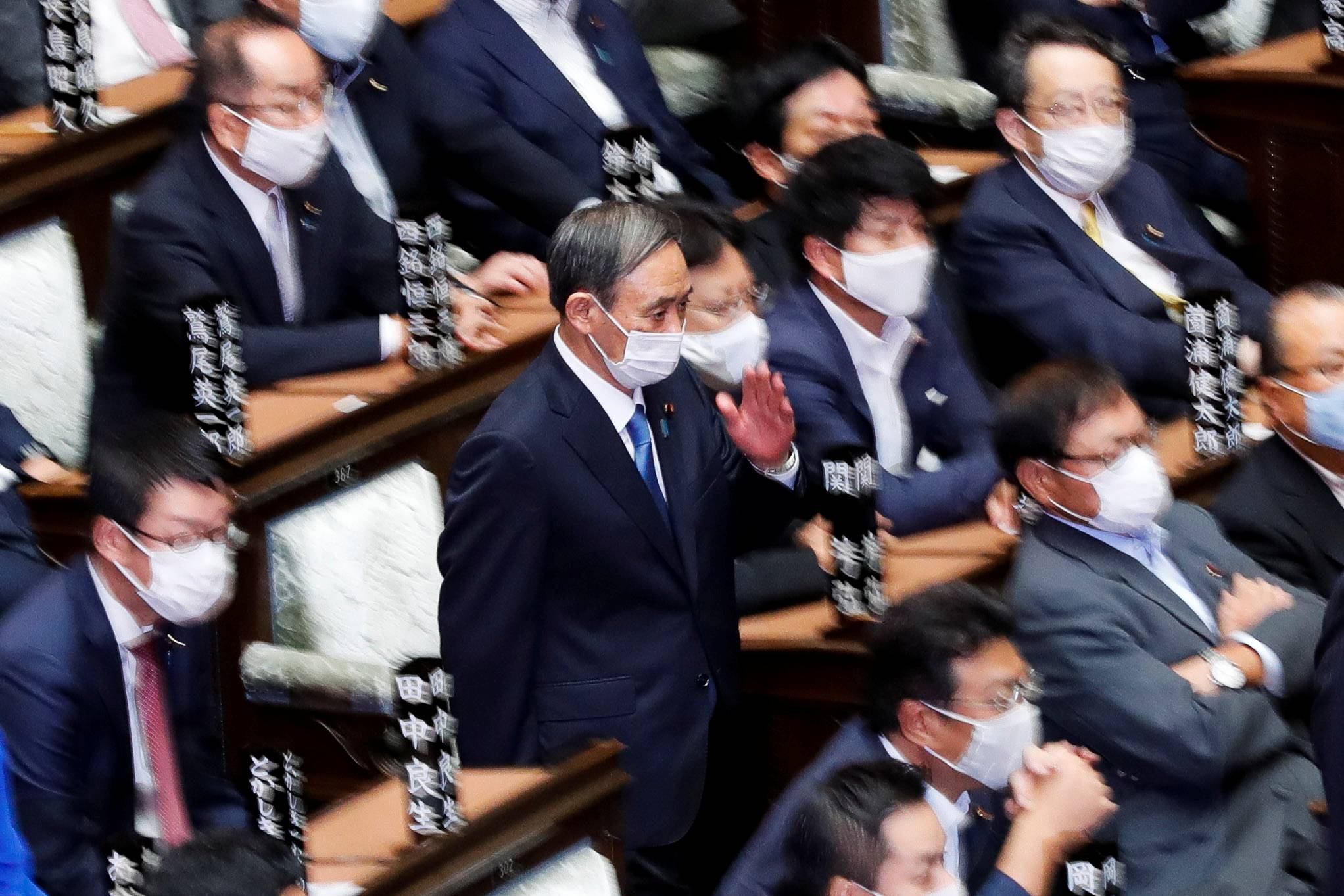 Yoshihide Suga, then chief Cabinet secretary, prepares to cast a vote to elect the new prime minister in the Diet's Lower House on Sept. 16. Now prime minister, Suga will speak before the Diet on Monday as it opens an extraordinary session.  | REUTERS 
