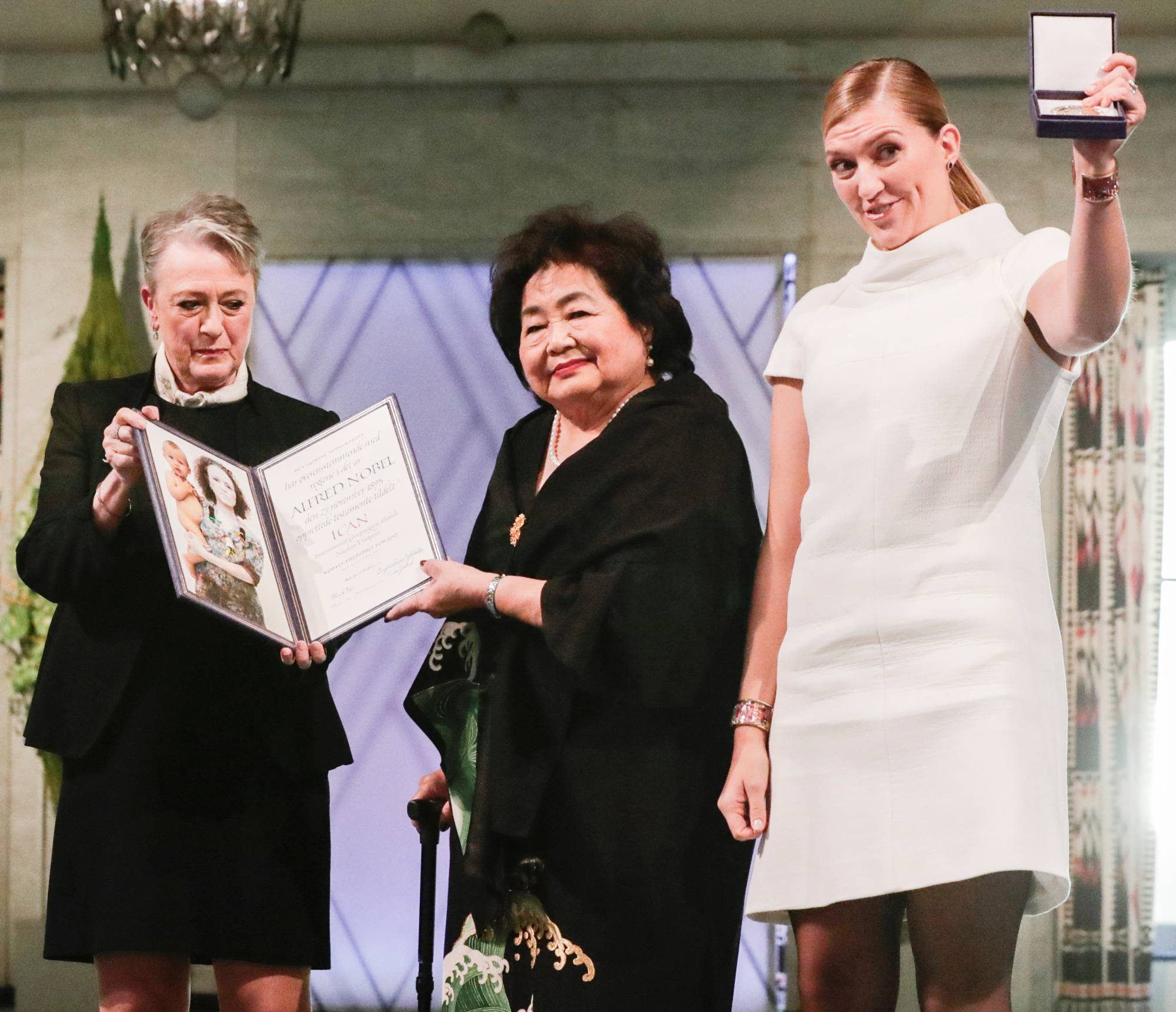 Hiroshima atomic bombing survivor Setsuko Thurlow (center) and ICAN Executive Director Beatrice Fihn (right) attend the awards ceremony for the Nobel Peace Prize in Oslo in December 2017. Thurlow and Finh led a successful campaign pushing for the ratification of the Treaty on the Prohibition of Nuclear Weapons. | NTB SCANPIX / TBERIT ROALD / VIA REUTERS    