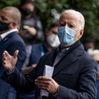 Democratic presidential candidate Joe Biden speaks with people outside a voter service center on Monday in Chester, Pennsylvania.  | AP