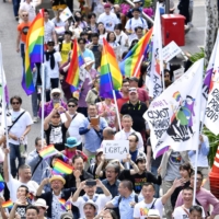 People hold a rally in Tokyo against discrimination toward sexual minorities in April 2019. | KYODO