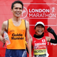 Misato Michishita celebrates with her guide after the women\'s para race at the London Marathon on April, 28, 2019. | REUTERS