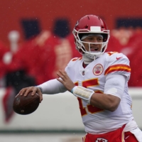 Chiefs quarterback Patrick Mahomes warms up before a game against the Broncos on Sunday in Denver. | AP
