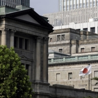 The Bank of Japan cut its growth forecast for the current year while keeping its key interest rates unchanged Thursday. | BLOOMBERG