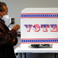 A woman casts her vote at a polling site in Milwaukee on Oct. 20.  | REUTERS