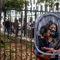A woman and her son wait in line to vote in New Orleans, Louisiana, earlier this month.  | REUTERS
