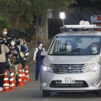 A police vehicle carrying actor Kentaro Ito leaves Harajuku Police Station in Tokyo on Thursday. | KYODO