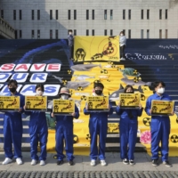 South Korean environmentalists stage a rally against Japan\'s disposal of radioactive water plan at the Fukushima nuclear power, in Seoul on Oct. 26. | AP