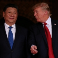 U.S. President Donald Trump talks with Chinese President Xi Jinping at the start of their summit in Florida in April 2017.  | REUTERS