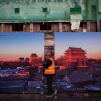 A worker leaves a construction site in Beijing on Wednesday,  | AFP-JIJI