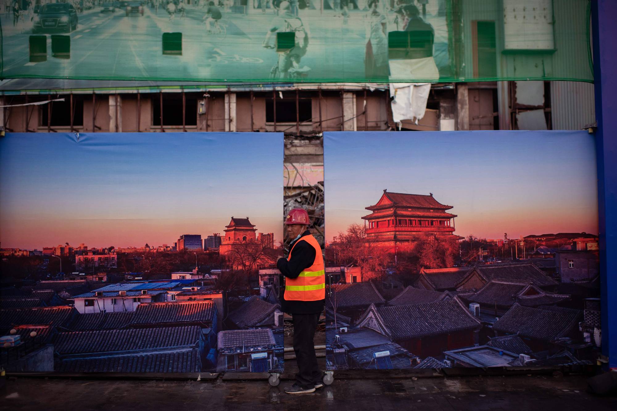 A worker leaves a construction site in Beijing on Wednesday, | AFP-JIJI