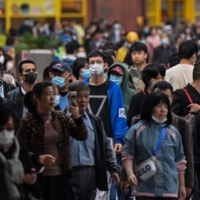 People walk along a pedestrian street in Shanghai on Wednesday.  | AFP-JIJI