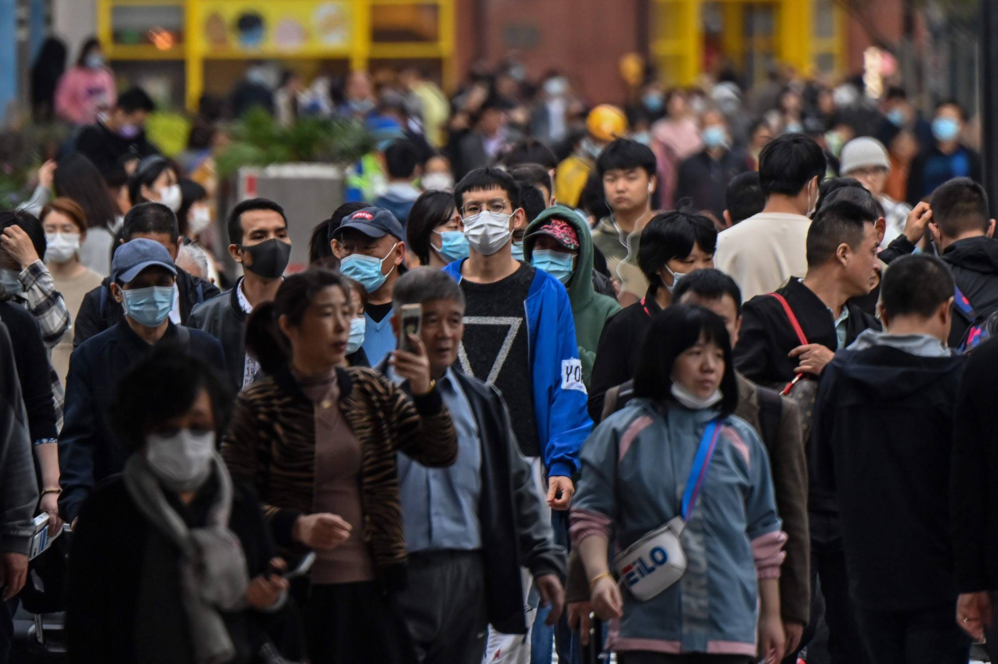 People walk along a pedestrian street in Shanghai on Wednesday. | AFP-JIJI