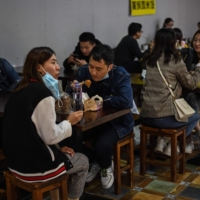 People eat at a restaurant in Shanghai on Oct. 25.  | AFP-JIJI